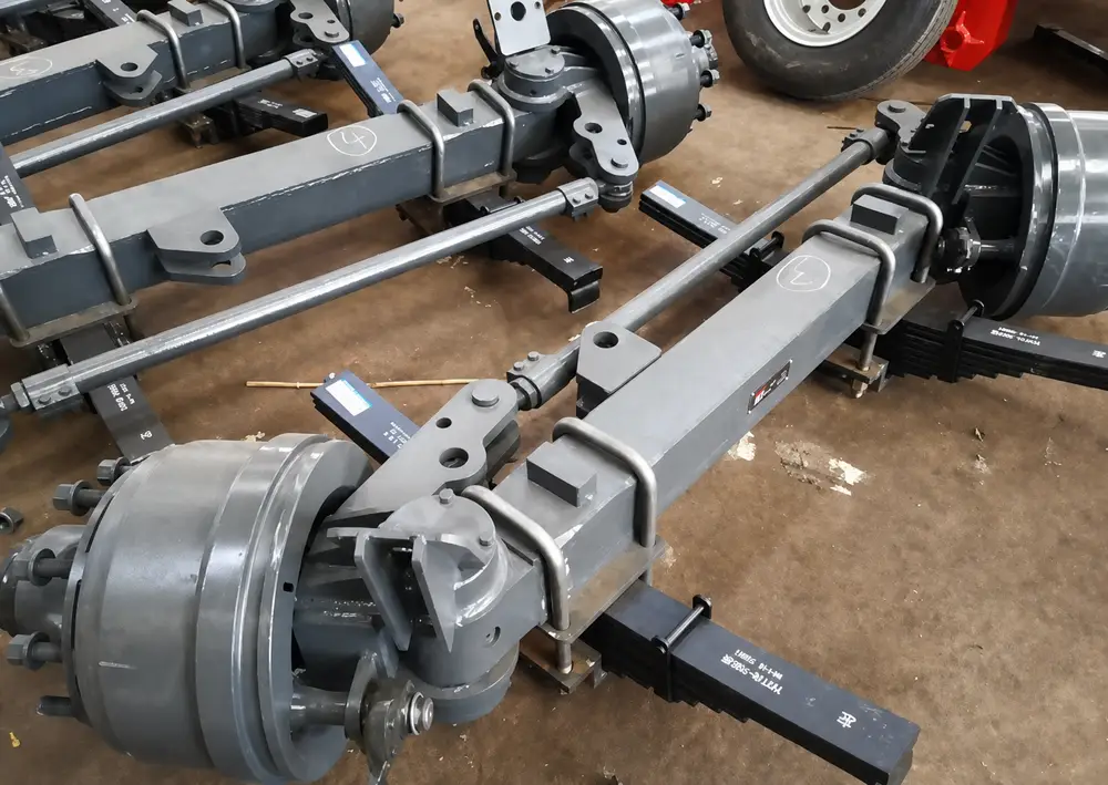 Self-steering axle assemblies and steering linkages