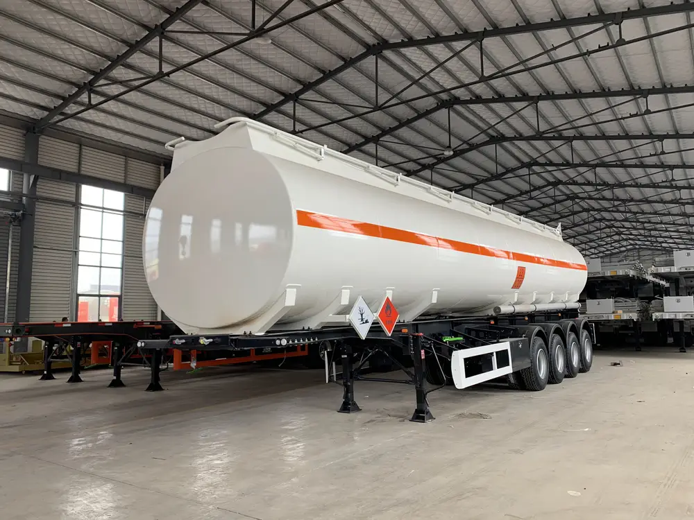 Q345B carbon steel fuel tanker trailer with hazard placards in factory warehouse