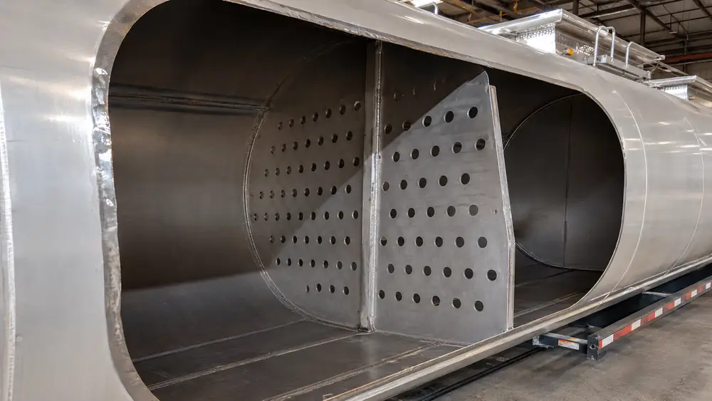 Internal baffle plates with staggered hole pattern inside a fuel tanker shell
