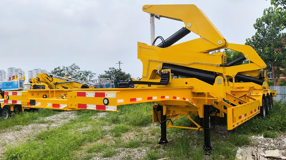A yellow sidelifter with both crane modules raised and stabilizer legs extended onto a gravel lot.