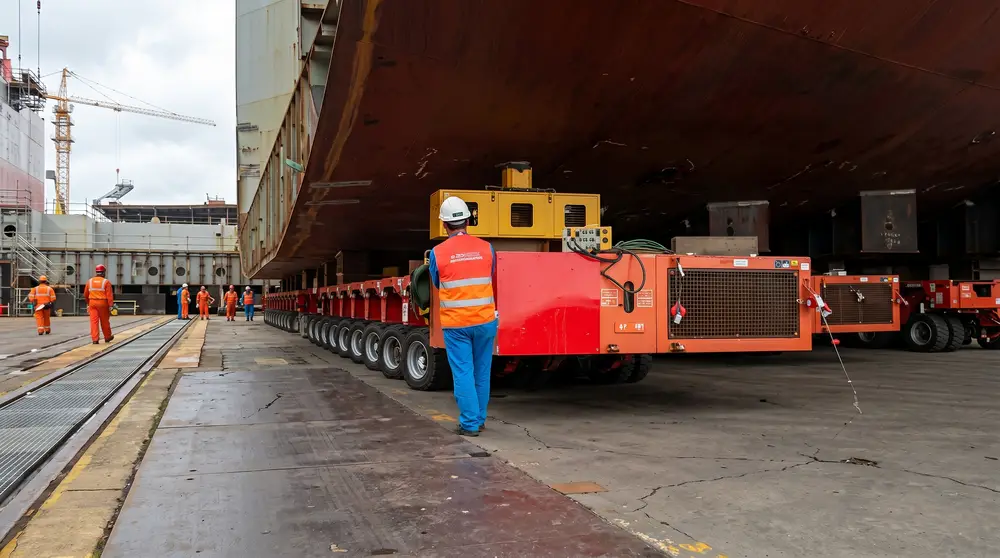 SPMTs positioned under a ship hull in dry dock
