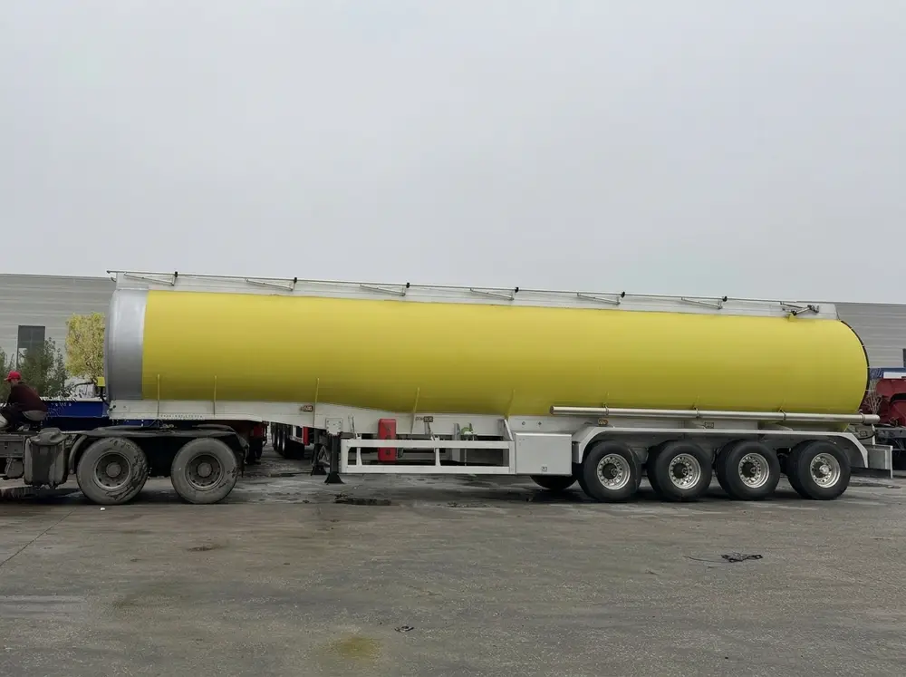 Completed 55 CBM fuel tanker — side profile showing 4-axle configuration and yellow-silver paint scheme