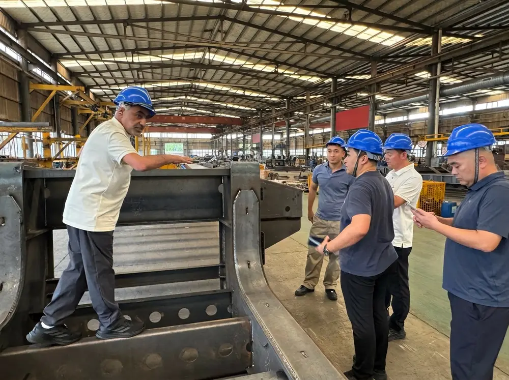 Engineers inspecting semi-trailer components during the factory walkthrough