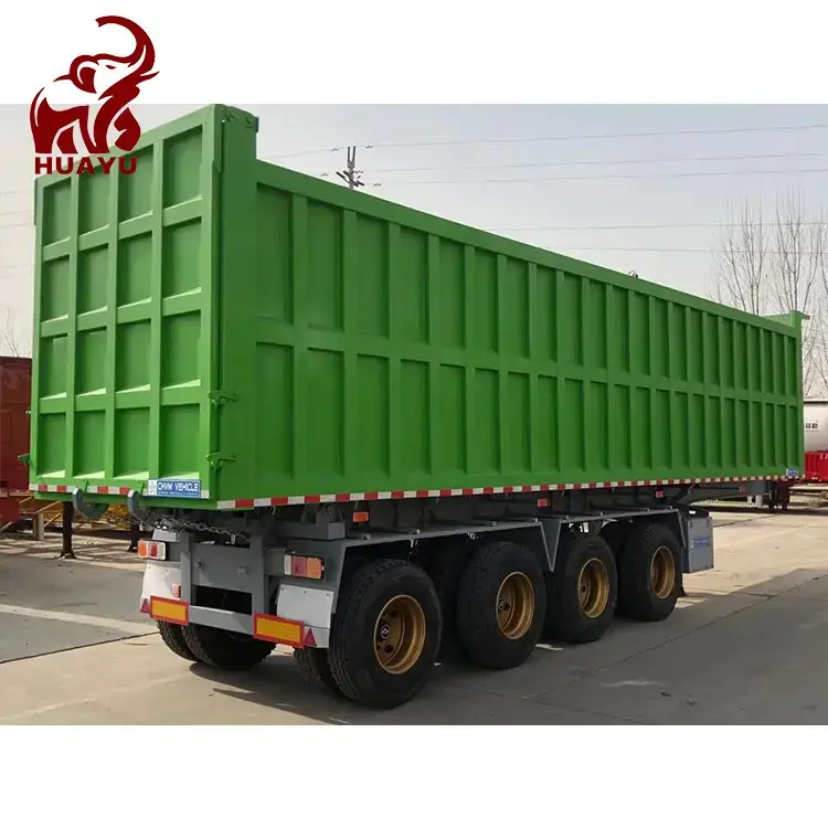 Green 4 axle dump tipper side view at HUAYU yard with paved surface