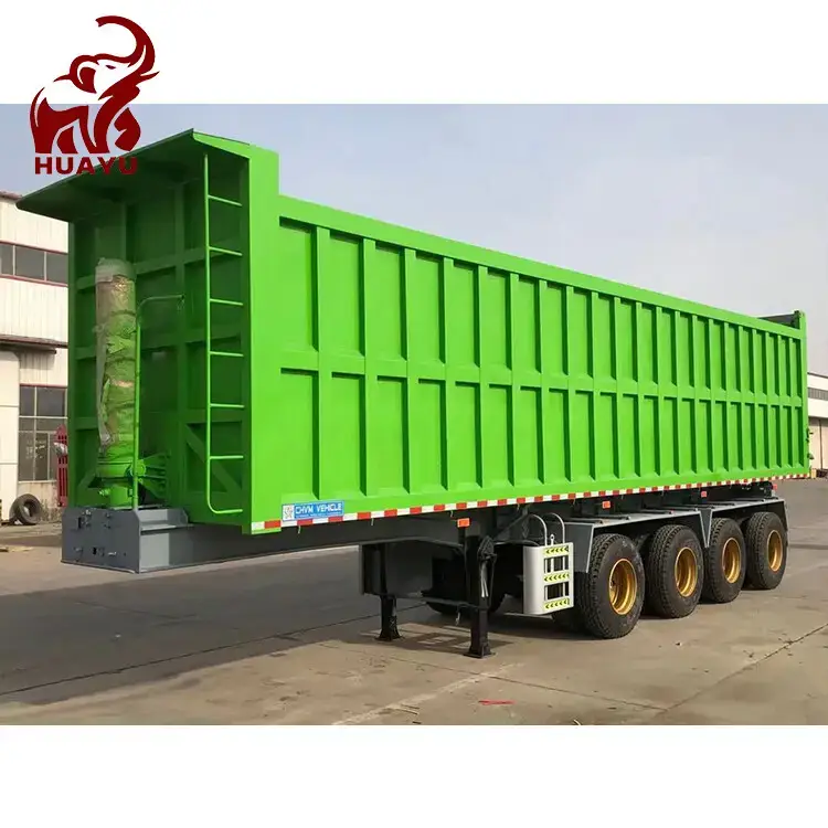 Green 4 axle dump tipper showing front-mounted hydraulic cylinder and headboard detail