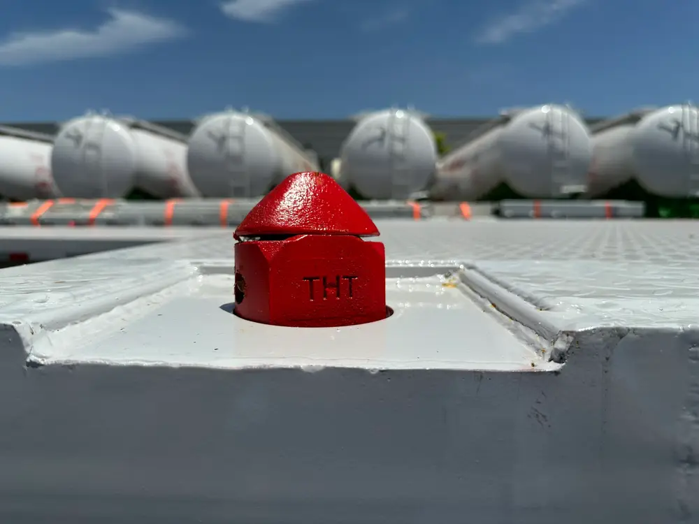 A retractable ISO twist lock seated in the side beam, one of twelve container locking points on the deck.