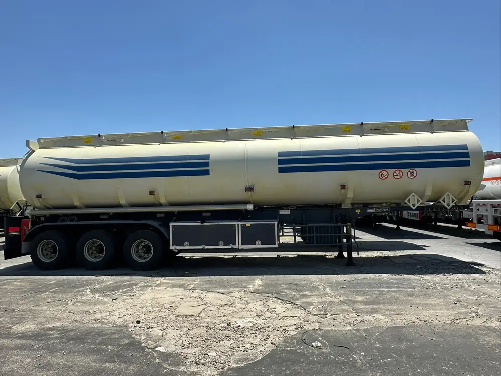 A 3 axle 45000L 5 compartment fuel tanker trailer with a full-length top walkway and five manholes at the HUAYU yard.