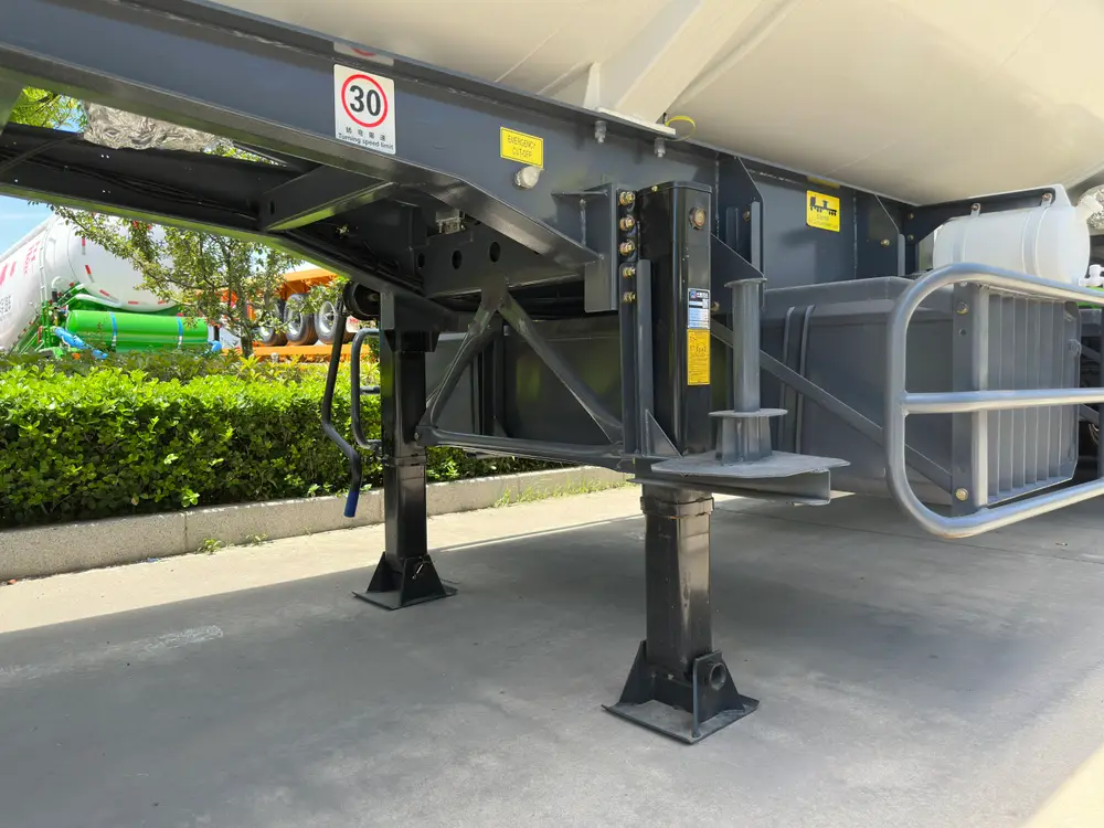Kingpin plate and landing gear area showing the emergency air line, yard speed decal, and side guard.