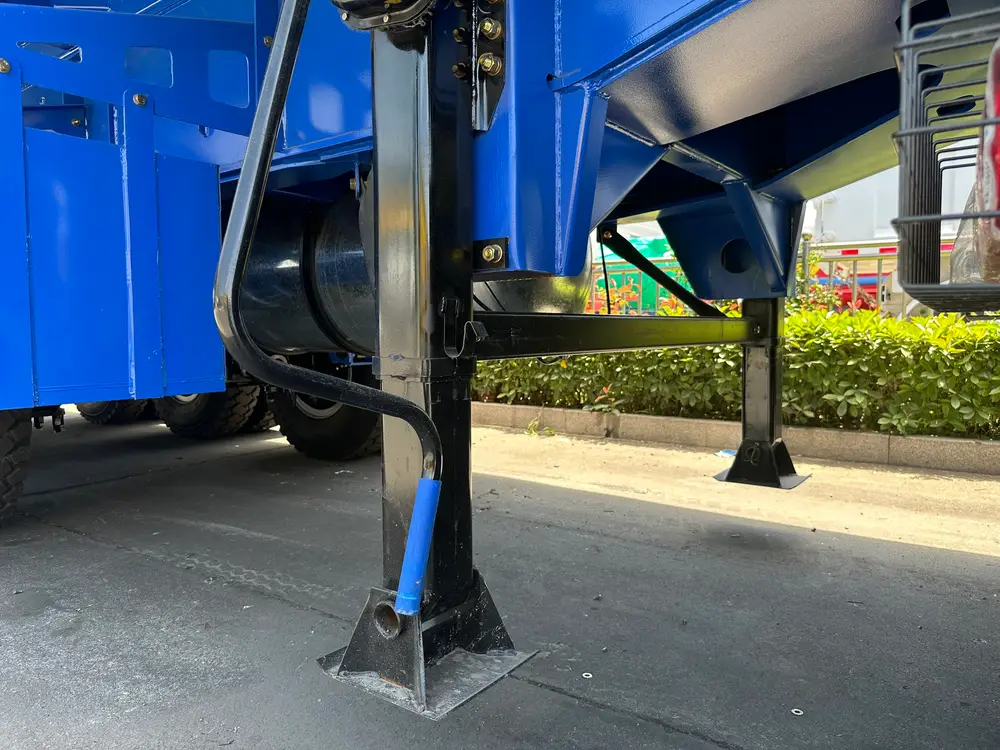 Two-speed 28 ton landing legs with sand shoes and the chassis-mounted air tank under the dump body.
