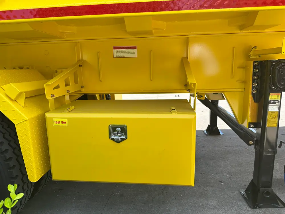A lockable yellow tool box mounted on the chassis side between the landing gear and the axle group.