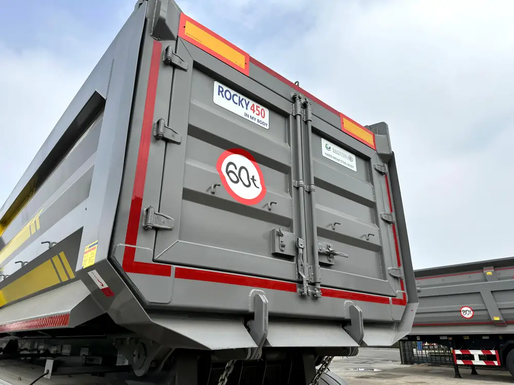 4 axle rock body dump trailer rear tailgate with Baosteel ROCKY 450 hard wear steel decal and 60 ton capacity stamp