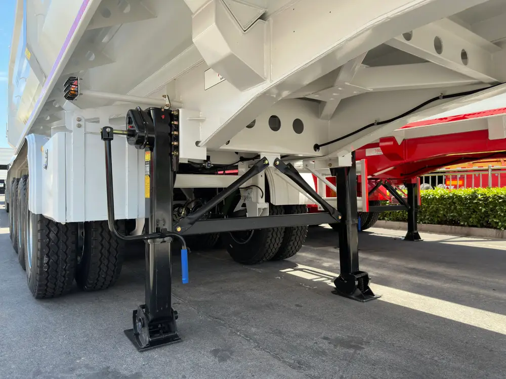 FUWA axle hubs and Aeolus tires with yellow torque-check markers under the mechanical leaf-spring suspension.